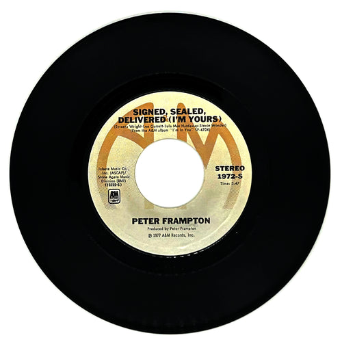 A vinyl record of Peter Frampton's album 'Signed, Sealed, Delivered (I'm Yours)' with the label showing the artist name, song title, and record details. The vinyl is black with a yellow and white label.