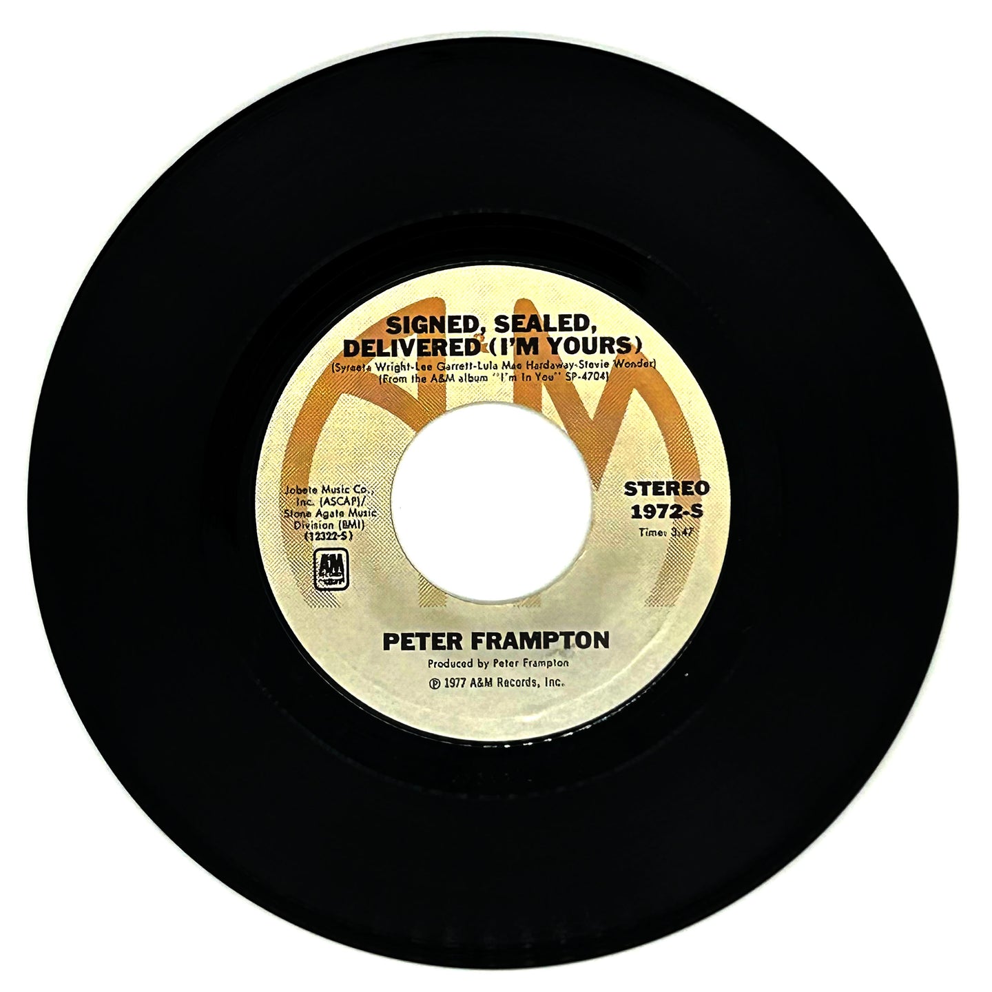 A vinyl record of Peter Frampton's album 'Signed, Sealed, Delivered (I'm Yours)' with the label showing the artist name, song title, and record details. The vinyl is black with a yellow and white label.